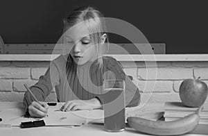 Cute little child studying in classroom at elementary school. Genius child, knowledge day. Kids education and knowledge.