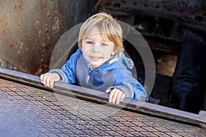 Cute little child tourist, admiring Barcelona city, standing in an old tank weapon in front of the castle Montjuic in Barcelona,