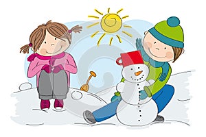 Cute little children boy and girl making a snowman