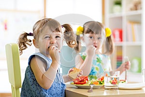 Cute little children eating food at daycare