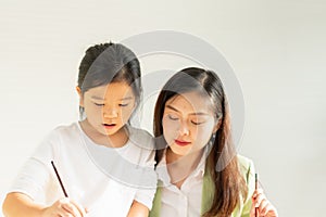 cute little children learn painting color with teacher in education classroom with copy space, select focus at child. asian