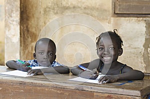 Cute Little Children Learning with Pens and Paper in Africa Sch