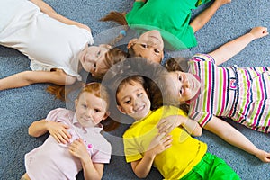 Cute little children lying on floor