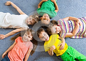 Cute little children lying on floor