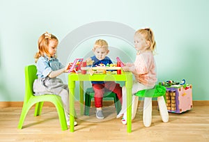 Cute little children playing in kindergarten room