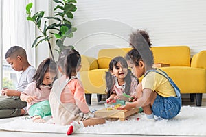 Cute little children playing toys in living room, Diverse children enjoying playing with toys photo