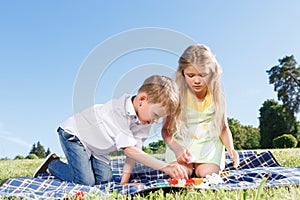 Cute little children sitting on the blanket