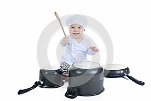 Cute little cook boy in front of a white