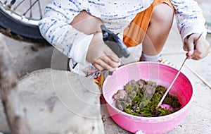 cute little curious girl touching green moss in outdoor box Curious childhood Children explore the world around them