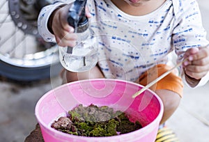 cute little curious girl touching green moss in outdoor box Curious childhood Children explore the world around them