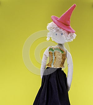 Cute little doll witch with pink witch hat and white curly hair