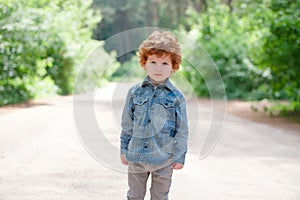 Cute little emotional boy outdoors