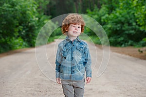 Cute little emotional boy outdoors