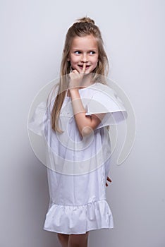 Cute little fashion model on white background. Beautiful girl studio shot.