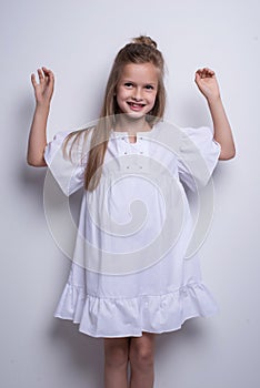 Cute little fashion model on white background. Beautiful girl studio shot.