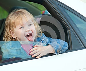 Cute little girl 3 years old, in the car