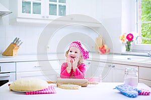 Cute little girl baking a pie