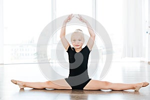 Cute little girl ballerina doing twine in ballet school