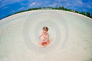 Cute little girl at beach during caribbean vacation