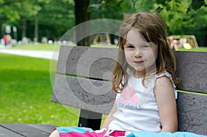 Cute little girl on a bench