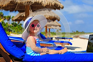 Cute little girl in big hat on summer beach