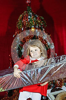 Cute little girl with big sweet christmas gift