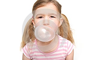 Cute little girl blowing a bubble from chewing gum