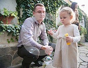 Cute little girl blowing soap bubbles