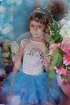 Cute little girl in a blue dress with flowers