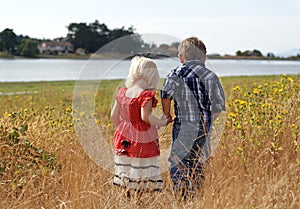 Cute Little Girl and Boy Holding Hands