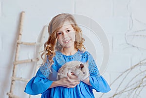 Cute little girl with a bunny rabbit has a Easter