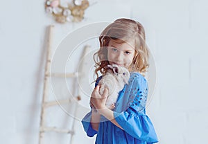 Cute little girl with a bunny rabbit has Easter