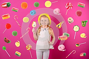 Cute little girl with candy on background