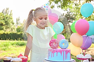 Cute little girl celebrating Birthday outdoors