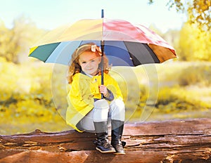 Cute little girl child with colorful umbrella