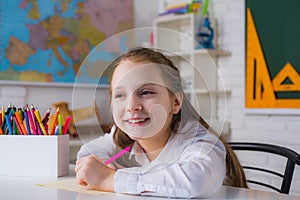 Cute little girl child kid drawing at home Elementary school. Funny little child having fun on blackboard background