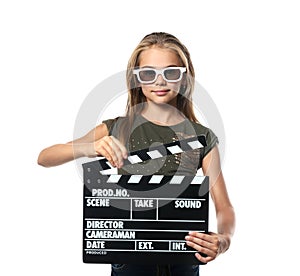 Cute little girl with clapper board wearing 3D cinema glasses on white background