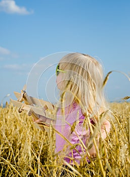 Cute little girl in a colorful hat and sunglasses