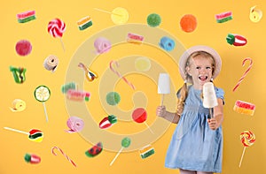 Cute little girl with cotton candies on color background.