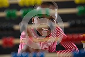 Cute little girl counting on abacus