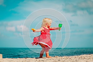 Cute little girl dance, child play at summer beach