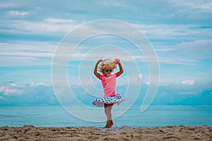 Cute little girl dance, child play at summer beach
