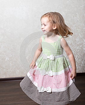 Cute little girl dancing, spinning in a dance, laughing