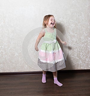 Cute little girl dancing, spinning in a dance, laughing