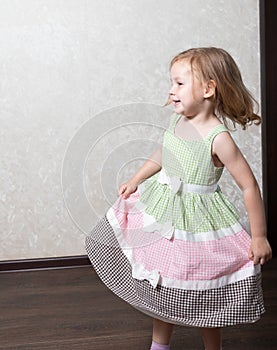 Cute little girl dancing, spinning in a dance, laughing