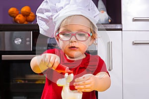 Girl decorating Christmas cookies with sugar icing