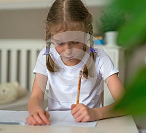 Cute little girl doing her homework.