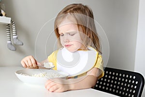 Cute little girl dont want to eat quark on kitchen