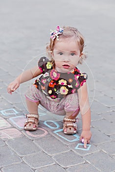 Cute little girl drawing with chalk