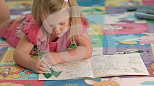 Cute little girl is drawing with felt-tip pen
